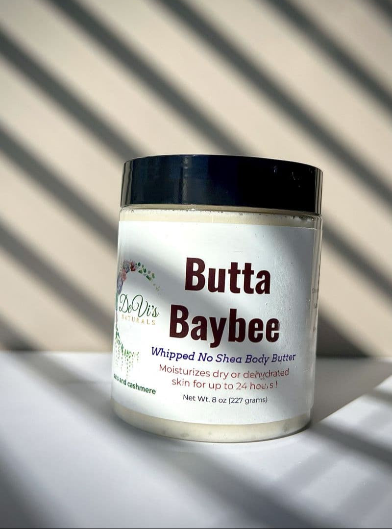 Jar of Butta Baybee whipped no shea body butter with a black lid on a light background