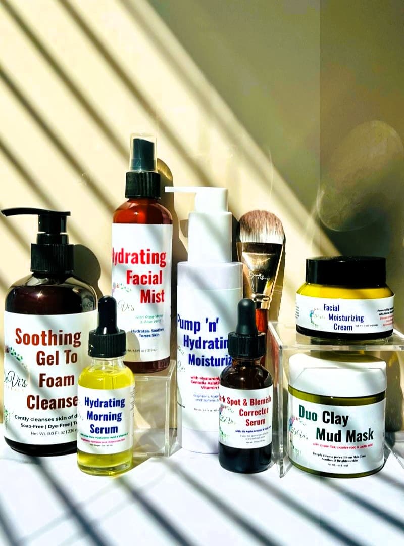 Collection of skincare products on a white surface with a reflective background