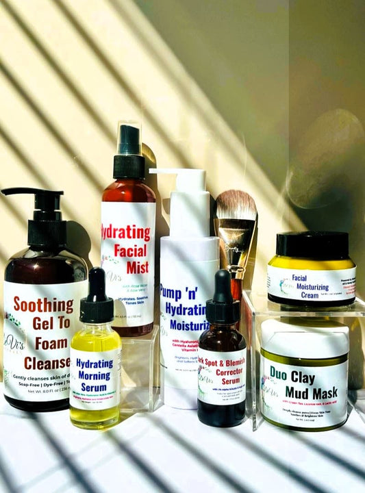 Collection of skincare products on a white surface with a reflective background