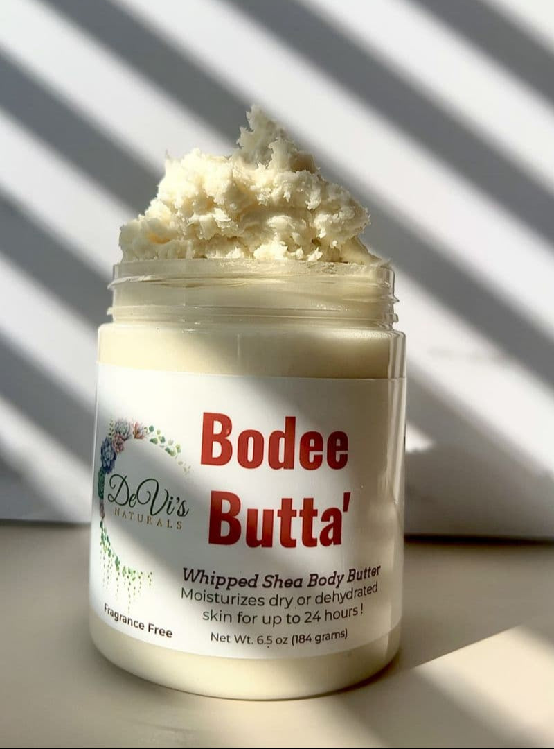 Jar of Bodee Butta whipped shea body butter with a striped background