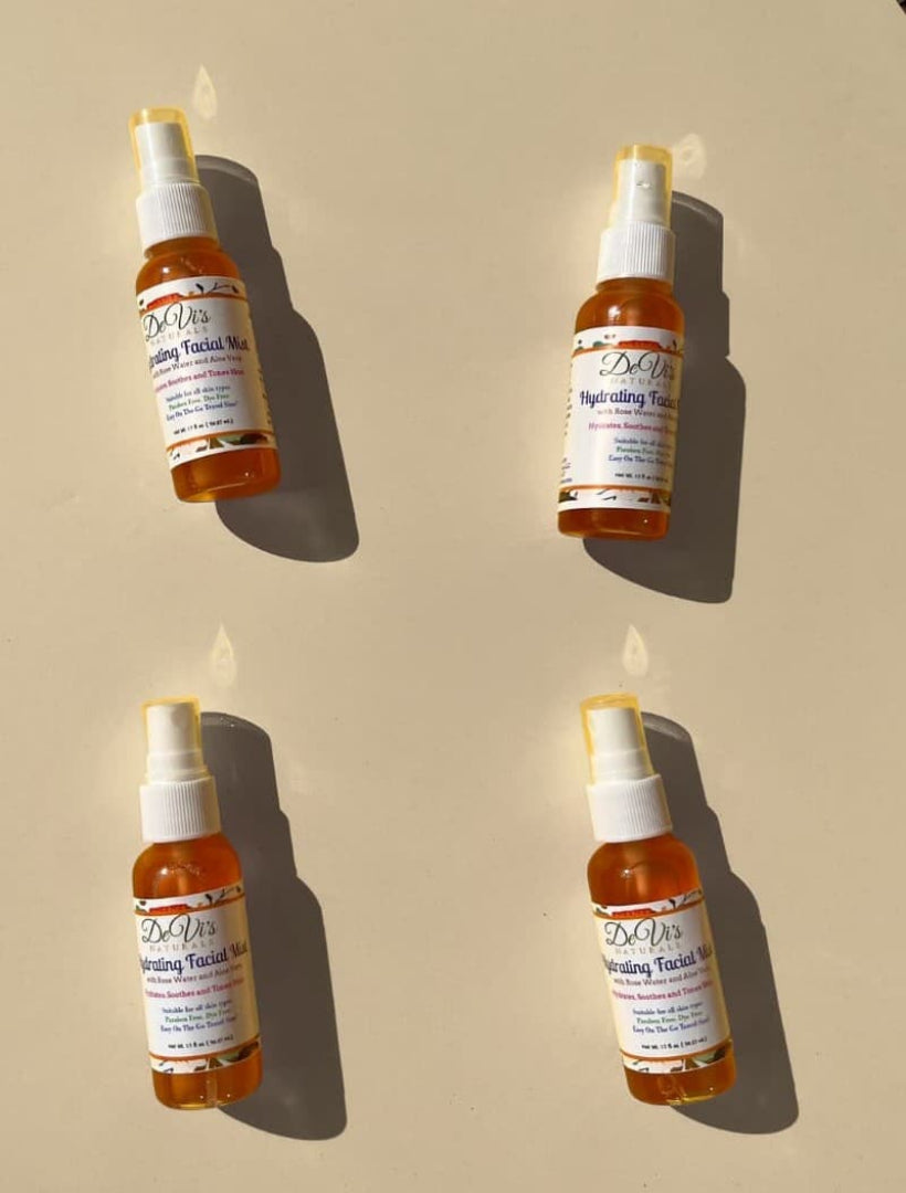 Four bottles of DeVi's hydrating mist on a beige background