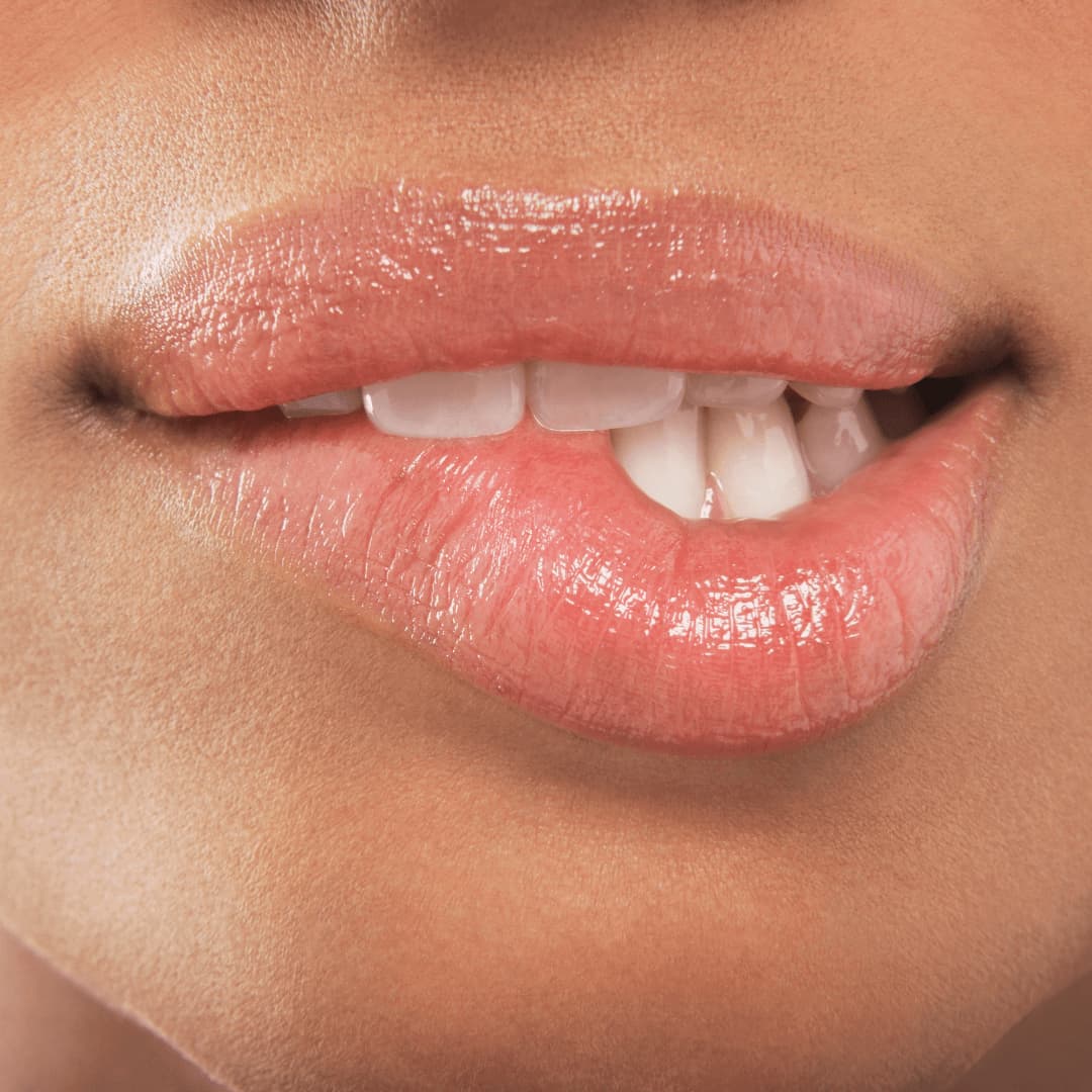 Close-up of a person's lips with a glossy lip color