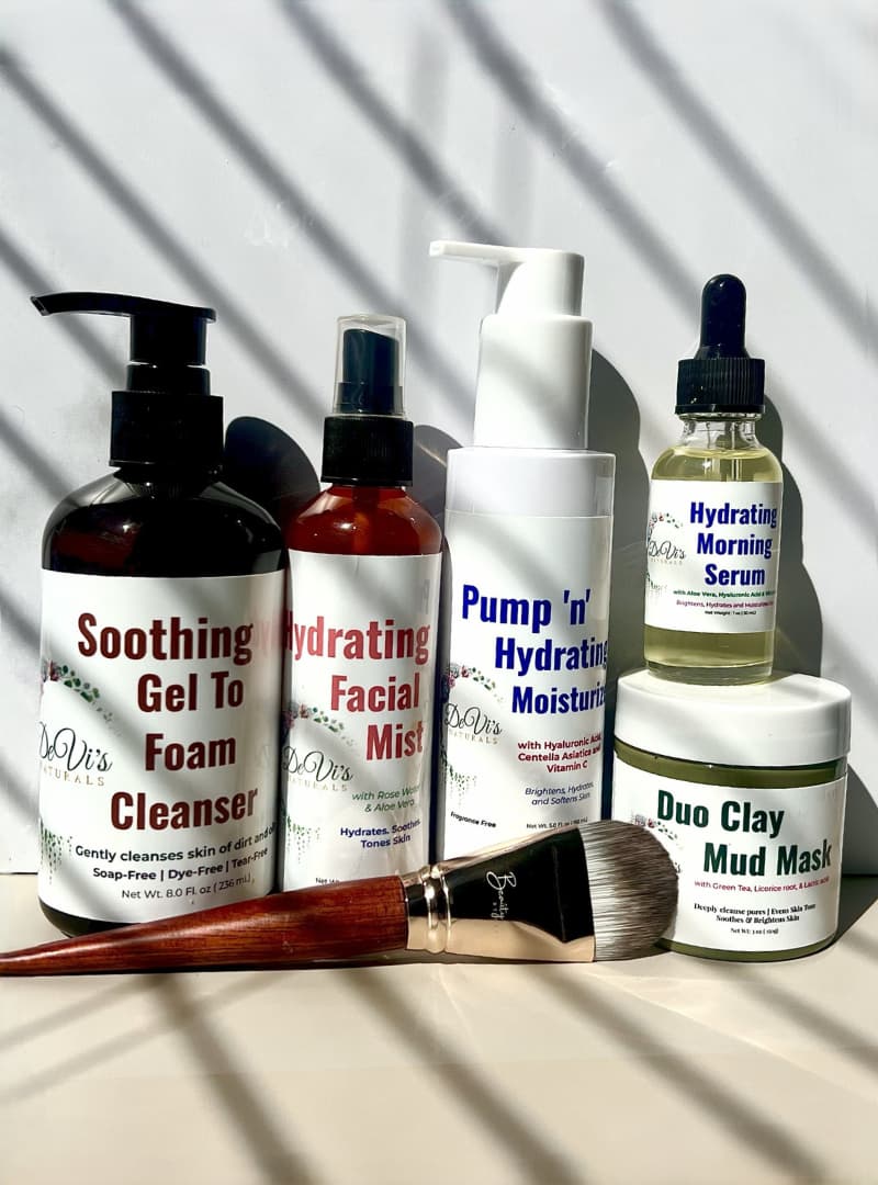 Collection of skincare products including bottles and a jar on a neutral background